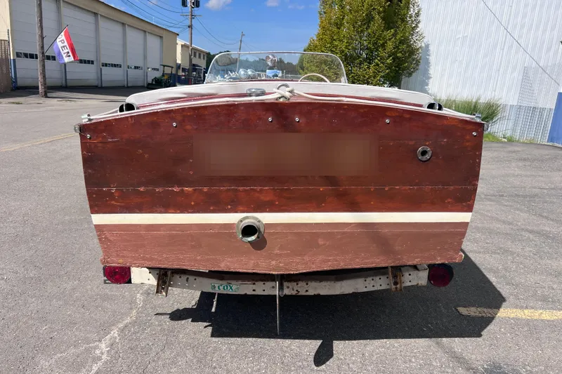Slide: The Image of 1955 Chris-Craft 17 Cavalier boat, rear view, parked outdoors on a sunny day. - 4