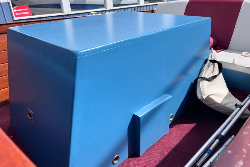 Slide: The Image of 1955 Chris-Craft 17 Cavalier interior with blue engine cover and maroon seating. - 7