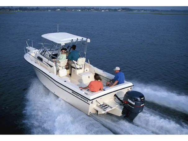 The Image of 2006 Grady-White Seafarer 228 boat on trailer, parked outdoors near trees. - 0