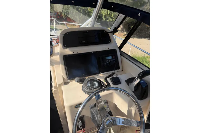 Slide: The Image of 2006 Grady-White Seafarer 228 boat with Yamaha outboard motor, parked on a driveway. - 14