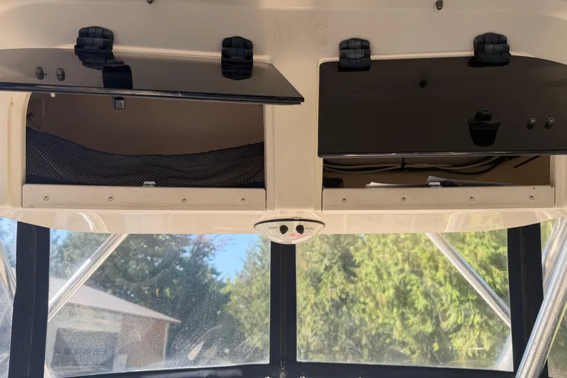 Slide: The Image of 2006 Grady-White Seafarer 228 boat dashboard with steering wheel and navigation instruments. - 19