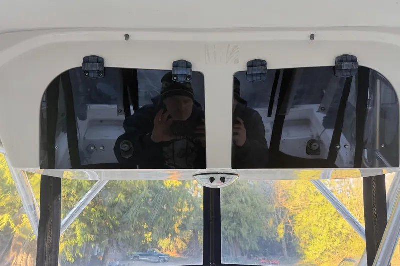 Slide: The Image of 2006 Grady-White Seafarer 228 boat interior with reflective surfaces and outdoor view. - 22