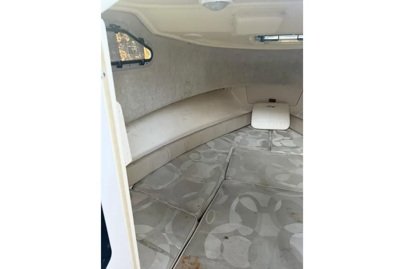 Slide: The Image of 2006 Grady-White Seafarer 228 cabin interior with cushioned seating and patterned flooring. - 25