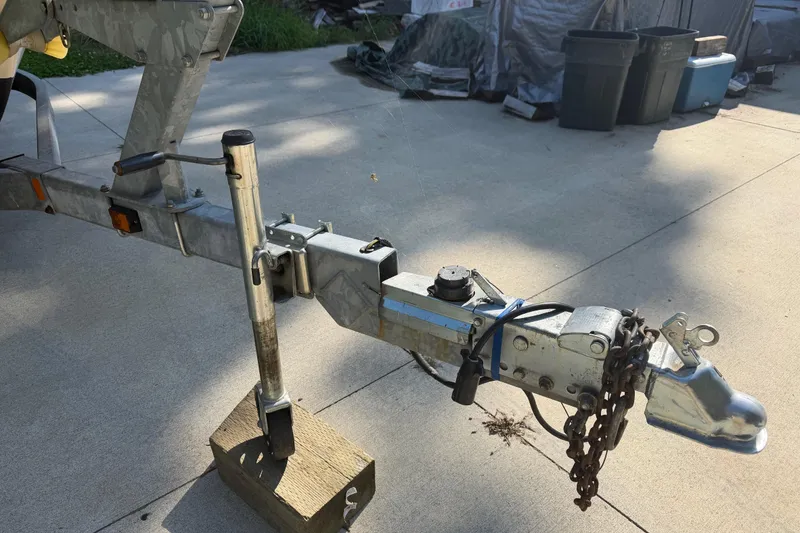 Slide: The Image of Trailer hitch of a 2006 Grady-White Seafarer 228 boat on concrete driveway. - 28