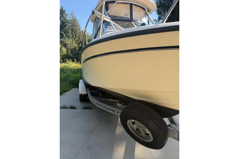 Slide: The Image of 2006 Grady-White Seafarer 228 boat on trailer, parked outdoors. - 4