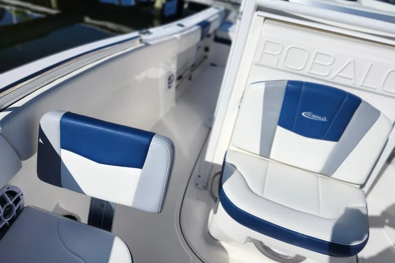 Slide: The Image of 2023 Robalo R230 Center Console boat interior with blue and white seating. - 14