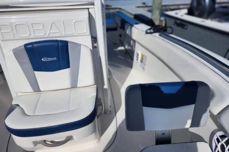 Slide: The Image of 2023 Robalo R230 Center Console boat interior with blue and white seating. - 15