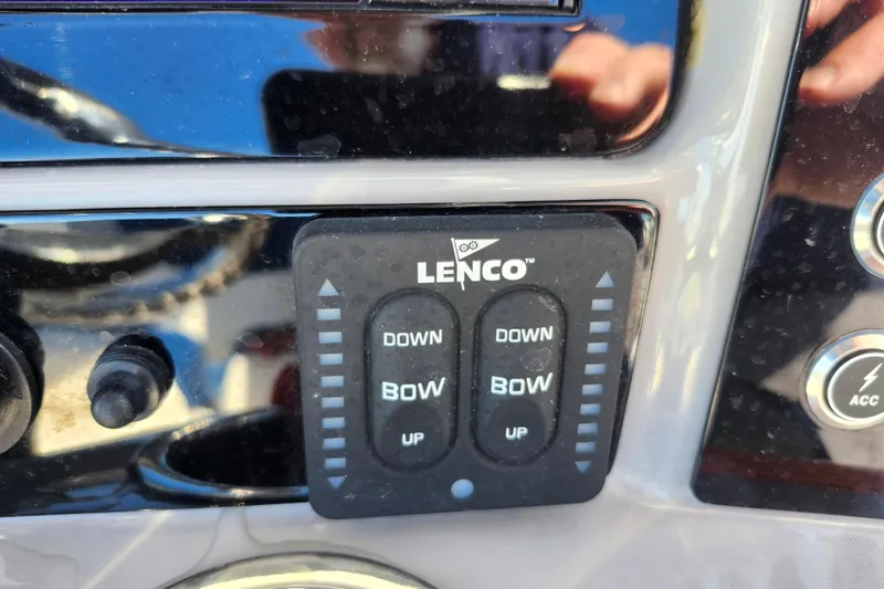 Slide: The Image of Control panel of 2023 Robalo R230 Center Console boat with Lenco trim tab switches. - 18