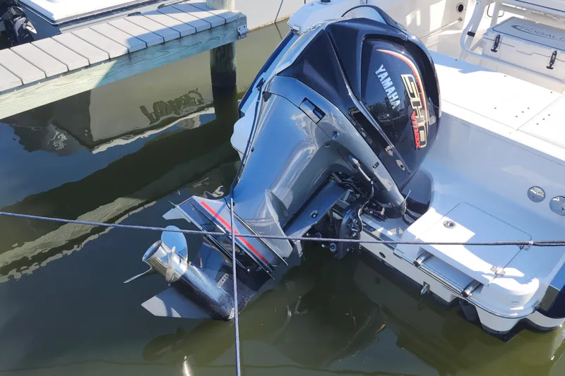 Slide: The Image of 2023 Robalo R230 Center Console with Yamaha outboard engine docked in marina. - 21