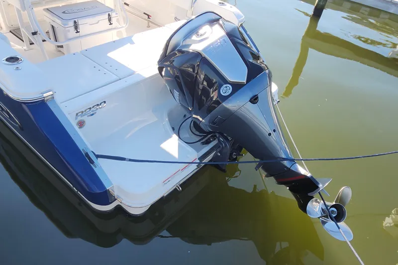 Slide: The Image of 2023 Robalo R230 Center Console boat with outboard motor in marina. - 22