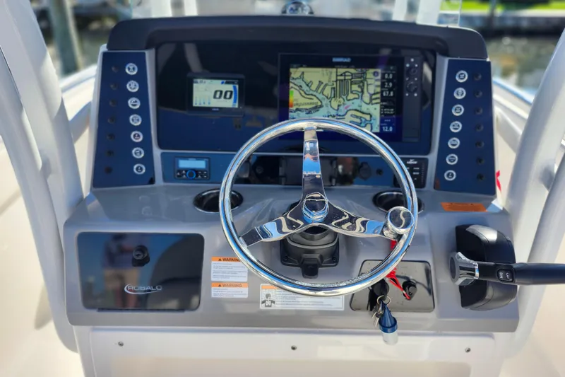 Slide: The Image of 2023 Robalo R230 Center Console dashboard with steering wheel and navigation display. - 5
