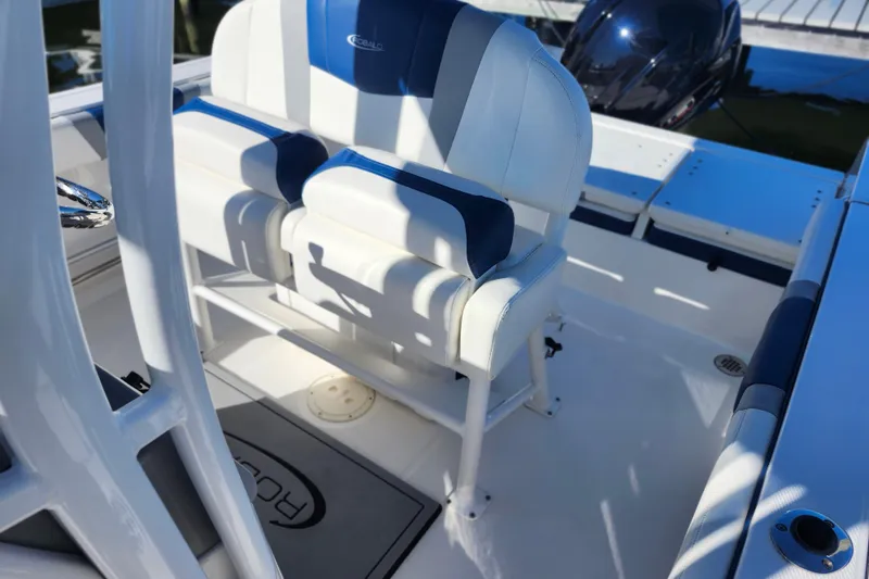 Slide: The Image of 2023 Robalo R230 Center Console boat interior with white and blue seating. - 8