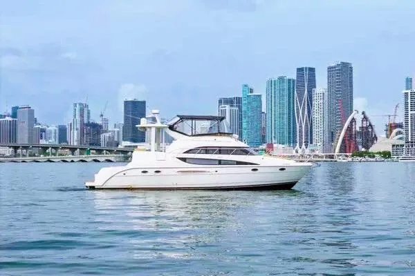 Slide: The Image of 2007 Meridian 459 Motoryacht cruising near a city skyline. - 3