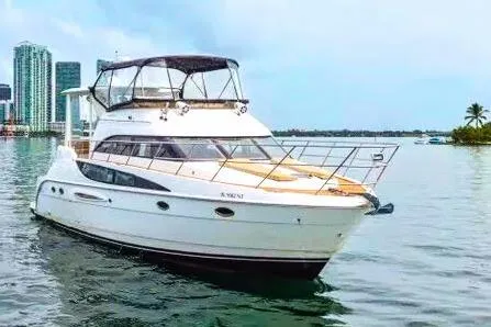 Slide: The Image of 2007 Meridian 459 Motoryacht cruising near a city skyline with modern skyscrapers. - 4