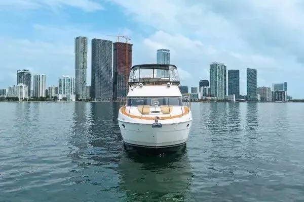 Slide: The Image of 2007 Meridian 459 Motoryacht on calm water, featuring sleek design and spacious deck. - 5