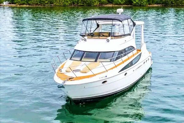 Slide: The Image of 2007 Meridian 459 Motoryacht on water, featuring spacious deck and elegant design. - 6