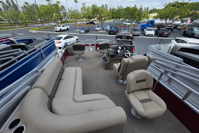 Slide: The Image of 2025 Sun Tracker Bass Buggy 18 DLX pontoon boat interior with seating and steering console. - 4
