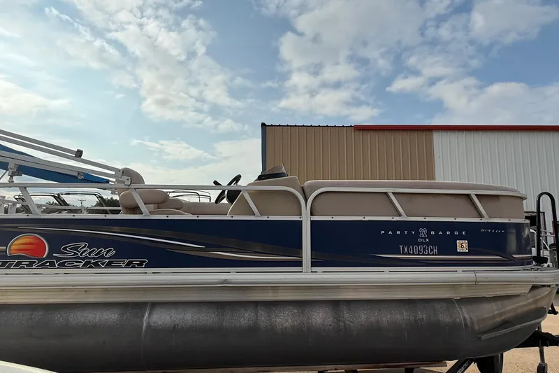 Slide: The Image of 2014 Sun Tracker Party Barge 22 DLX pontoon boat under a partly cloudy sky. - 4