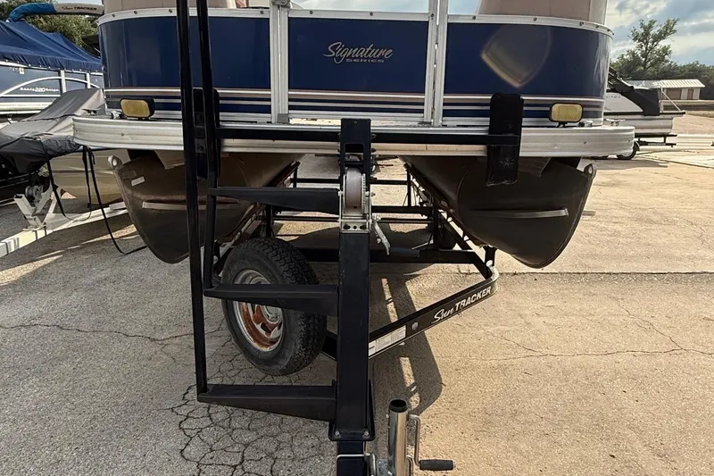 Slide: The Image of 2014 Sun Tracker Party Barge 22 DLX on trailer, rear view, parked on concrete. - 7