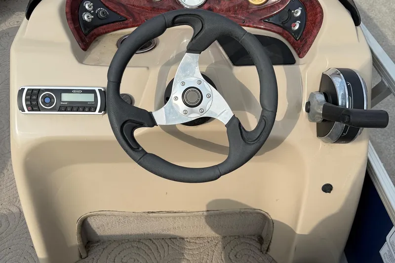 Slide: The Image of Steering console of 2014 Sun Tracker Party Barge 22 DLX with controls and radio. - 8