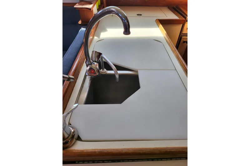 Slide: The Image of 1993 Catalina 34 yacht galley sink with faucet and custom covers. - 13