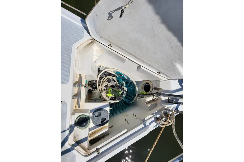 Slide: The Image of Open anchor locker storage compartment on 1993 Catalina 34 sailboat, showing electric windlass. - 17