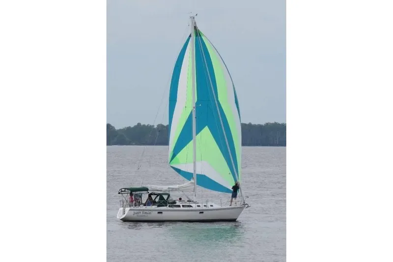 Slide: The Image of Sailboat Catalina 34 (1993) with colorful spinnaker on calm water. - 21