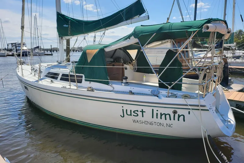 Slide: The Image of 1993 Catalina 34 sailboat docked, named "Just Limin'," with green canopy in Washington, NC. - 3
