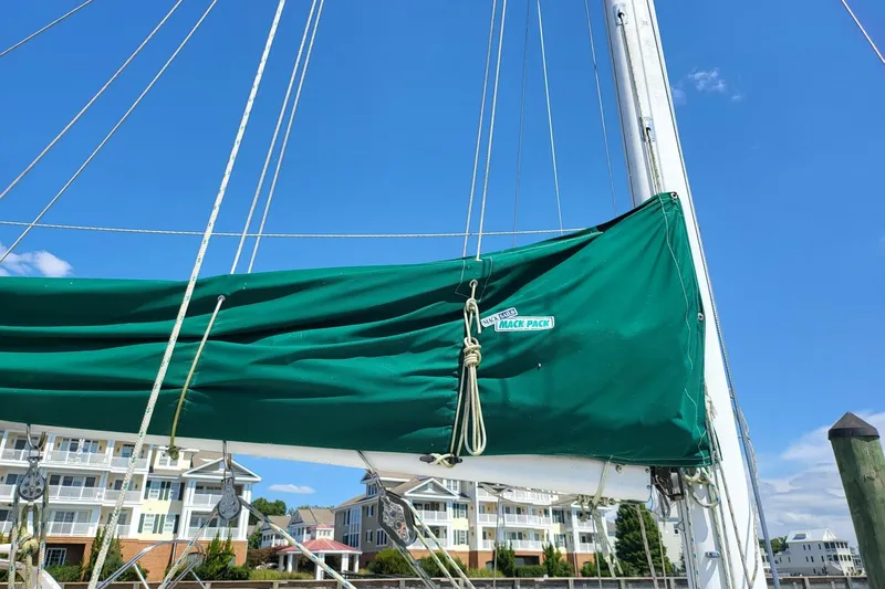 Slide: The Image of Sailboat green sail cover, Catalina 34, 1993 model, with lazy jacks. - 4