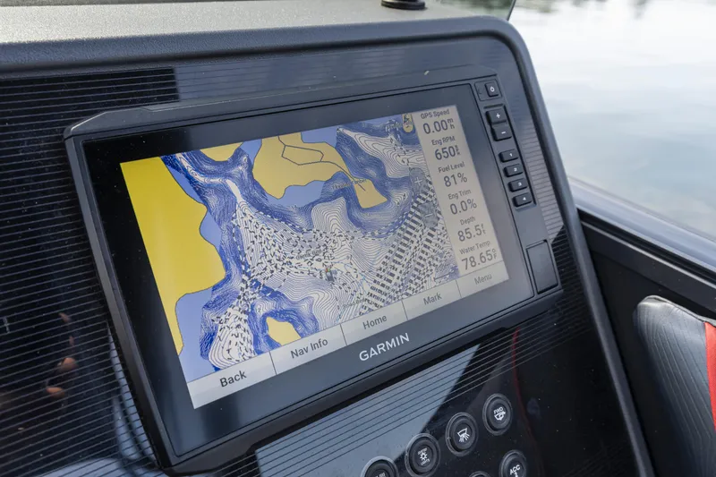 Slide: The Image of Garmin navigation display on 2024 Manitou 22 Explore Max Bench boat dashboard. - 13