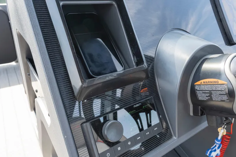 Slide: The Image of 2024 Manitou 22 EXPLORE MAX BENCH dashboard with control panel and warning label. - 15