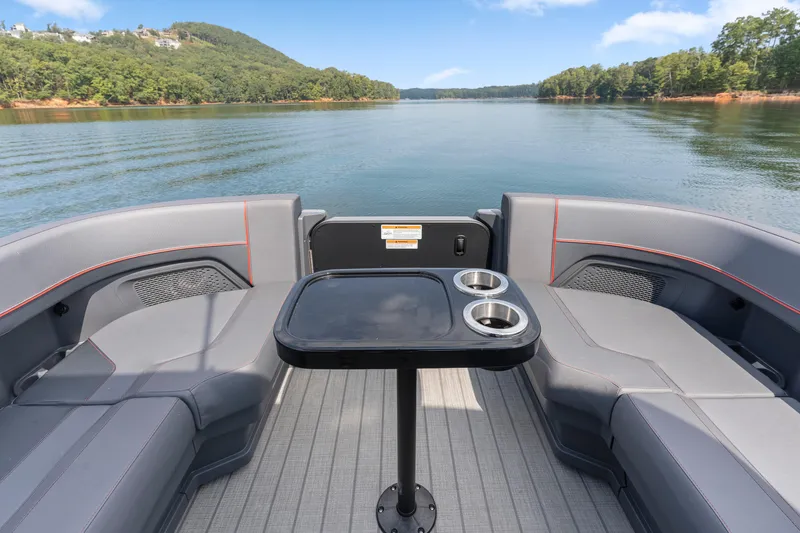 Slide: The Image of 2024 Manitou 22 Explore Max Bench pontoon boat interior with lake view. - 21