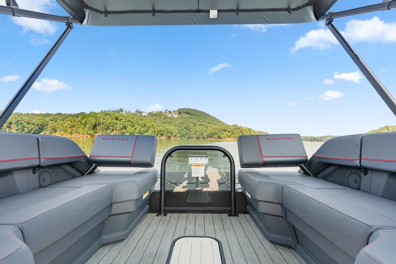 Slide: The Image of 2024 Manitou 22 Explore Max Bench pontoon boat interior with lake view. - 5