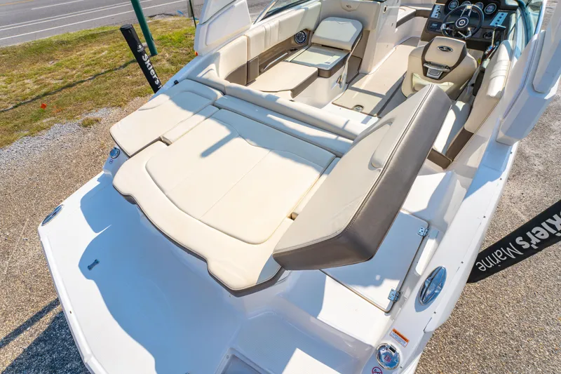 Slide: The Image of 2021 Chaparral 237 SSX boat interior with beige seating and modern dashboard. - 16