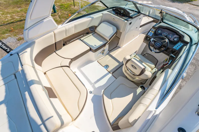 Slide: The Image of 2021 Chaparral 237 SSX boat interior with beige seating and modern dashboard. - 18