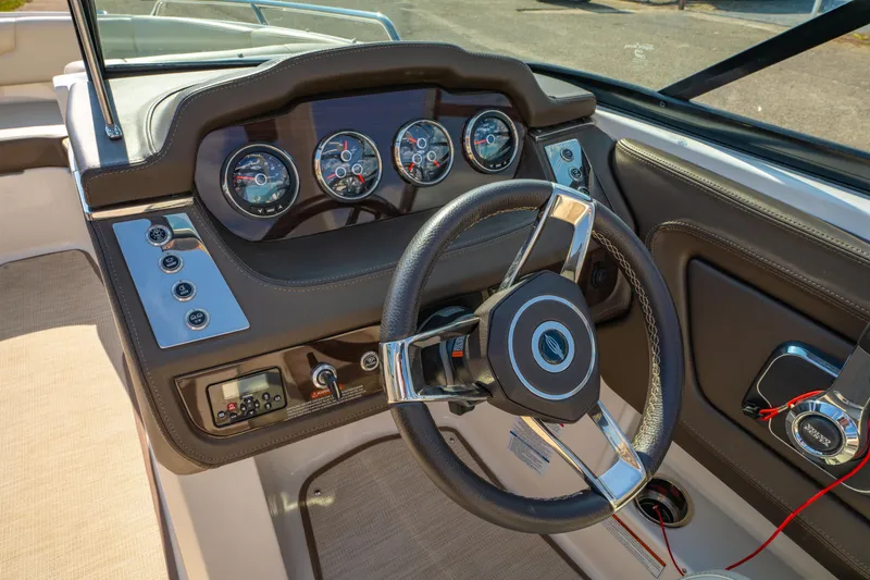 Slide: The Image of 2021 Chaparral 237 SSX boat dashboard with steering wheel and instrument panel. - 19