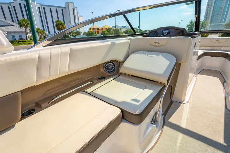 Slide: The Image of 2021 Chaparral 237 SSX boat interior with beige seating and modern dashboard. - 21