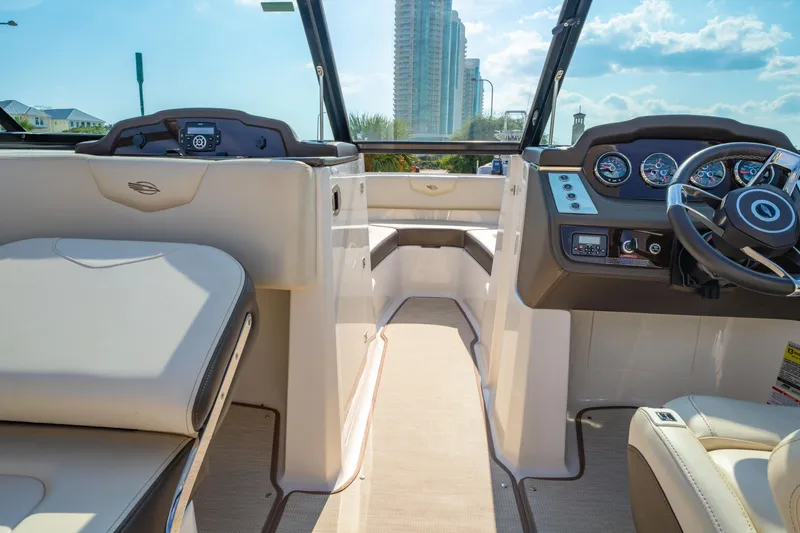 Slide: The Image of Interior view of 2021 Chaparral 237 SSX boat, featuring modern dashboard and seating. - 23