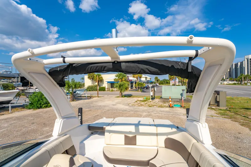 Slide: The Image of 2021 Chaparral 237 SSX boat with sleek design and spacious seating, parked outdoors. - 27