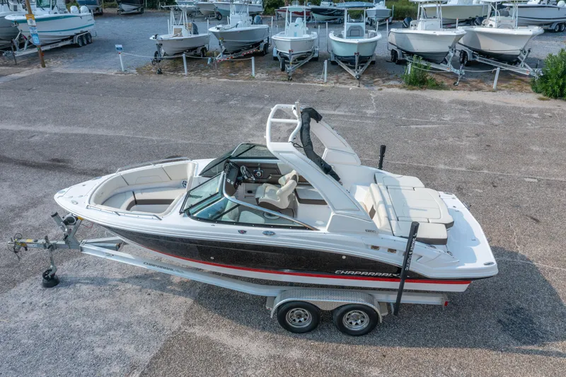 Slide: The Image of 2021 Chaparral 237 SSX boat on trailer, parked in a marina with other boats. - 3