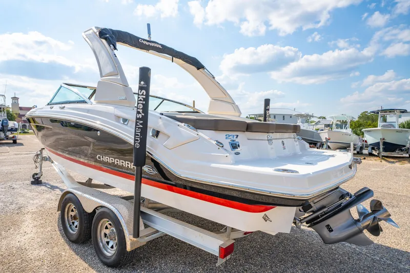Slide: The Image of 2021 Chaparral 237 SSX boat on trailer under a sunny sky. - 6