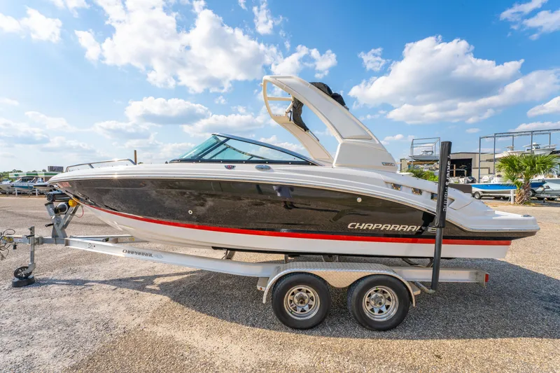 Slide: The Image of 2021 Chaparral 237 SSX boat on trailer under a blue sky. - 7