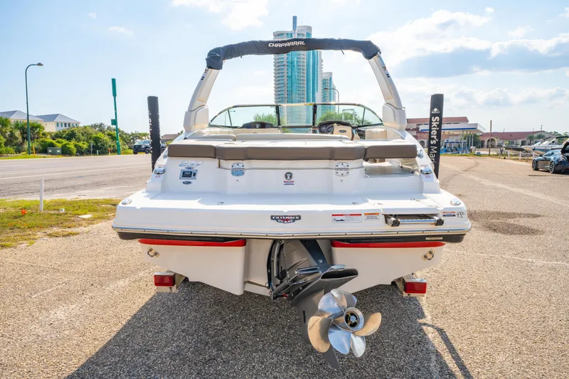 Slide: The Image of 2021 Chaparral 237 SSX boat rear view, parked on a sunny day. - 9