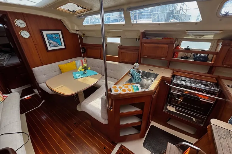 Slide: The Image of Interior of a 1993 Hunter 33.5 sailboat with cozy dining and kitchen area. - 13
