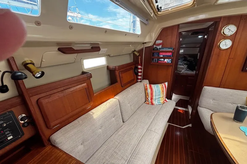 Slide: The Image of Interior of a 1993 Hunter 33.5 sailboat with cozy seating and wooden accents. - 14