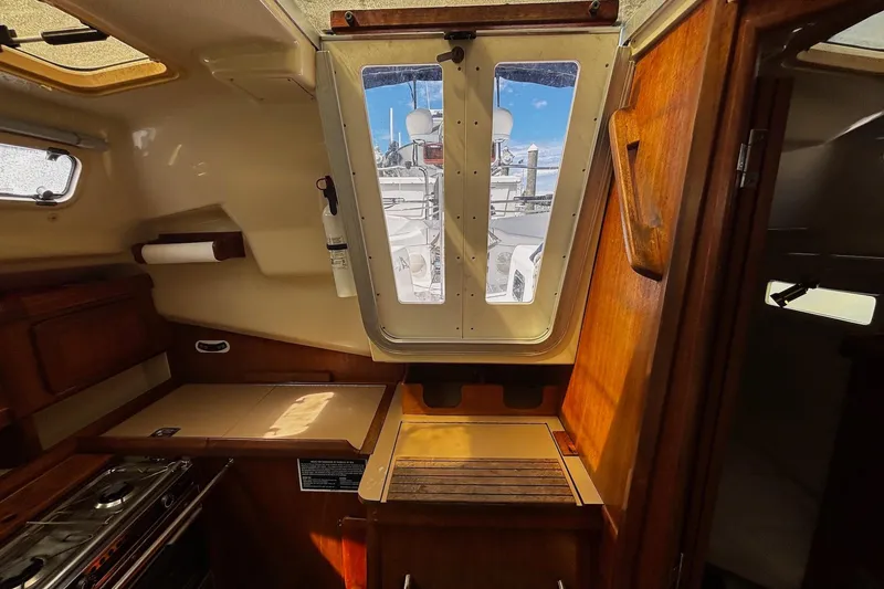 Slide: The Image of Interior of 1993 Hunter 33.5 sailboat with wooden cabinetry and a view through the hatch. - 20