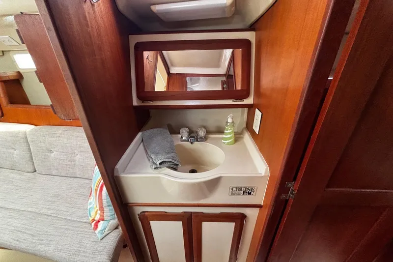Slide: The Image of Compact bathroom sink area in a 1993 Hunter 33.5 sailboat interior. - 23
