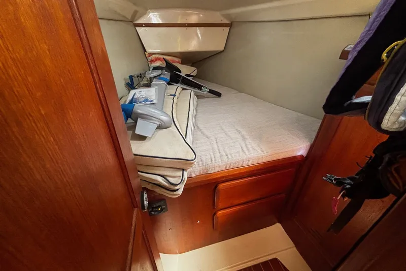 Slide: The Image of Cozy cabin interior of 1993 Hunter 33.5 sailboat with wooden finish and storage. - 25