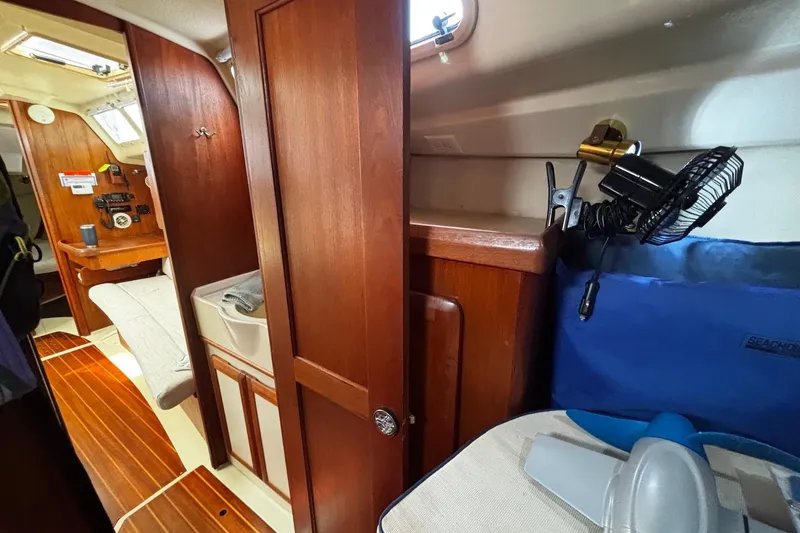 Slide: The Image of Interior of 1993 Hunter 33.5 sailboat with wooden cabinetry and compact living space. - 27