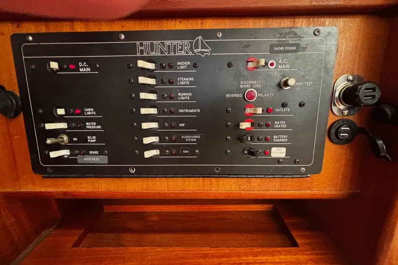 Slide: The Image of Control panel of a 1993 Hunter 33.5 sailboat with various switches and indicators. - 28